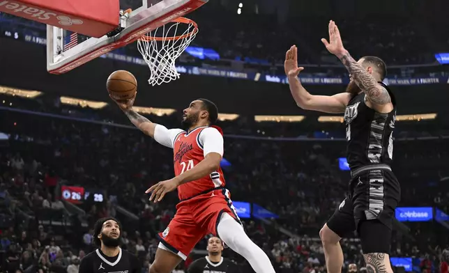 Los Angeles Clippers guard Norman Powell (24) shoots a layup during the first half of an NBA basketball game against the San Antonio Spurs, Tuesday, April 8, 2025, in Inglewood, Calif. (AP Photo/Carrie Giordano)