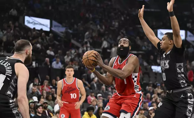 Los Angeles Clippers guard James Harden (1) looks to shoot during the first half of an NBA basketball game against the San Antonio Spurs, Tuesday, April 8, 2025, in Inglewood, Calif. (AP Photo/Carrie Giordano)