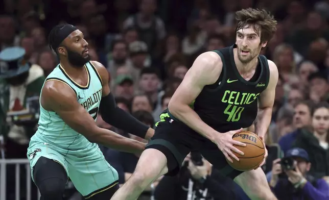 Boston Celtics' Luke Kornet (40) looks to move against Charlotte Hornets' Josh Okogie during the first half of an NBA basketball game Sunday, April 13, 2025, in Boston. (AP Photo/Michael Dwyer)
