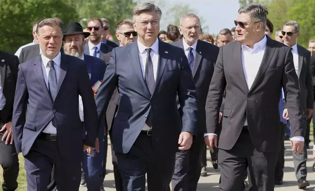 From left, Croatian Parliament Speaker Goran Jandrokovic, Prime Minister Andrej Plenkovic and President Zoran Milanovic walk towards the monument commemorating victims of a World War II concentration camp, where tens of thousands of people perished in the hands of the pro-Nazi puppet regime at the time, in Jasenovac, Croatia, Tuesday, April 22, 2025. (AP Photo)
