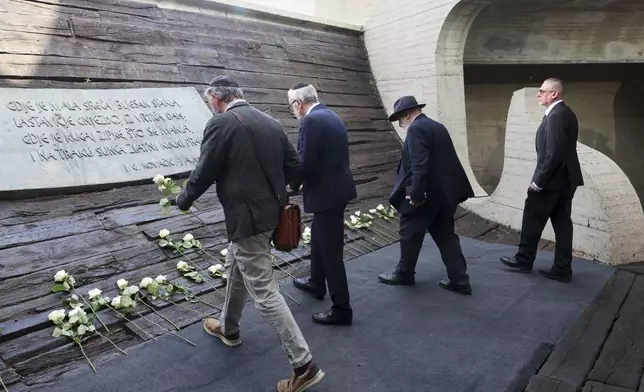 Representatives of the Jewish community lay flowers at the monument commemorating victims of a World War II concentration camp, where tens of thousands of people perished in the hands of the pro-Nazi puppet regime at the time, in Jasenovac, Croatia, Tuesday, April 22, 2025. (AP Photo)