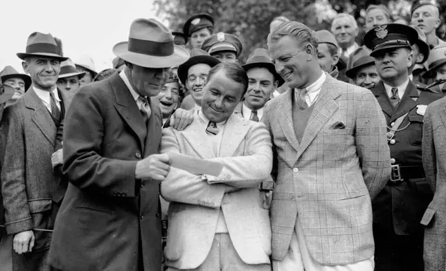 FILE - In this April 8, 1935, file photo, golfer Gene Sarazen, center, receives a check for $1,500 from sportswriter Grantland Rice, left, for winning the Augusta National Invitation Tournament in Augusta, Ga. (AP Photo/File)