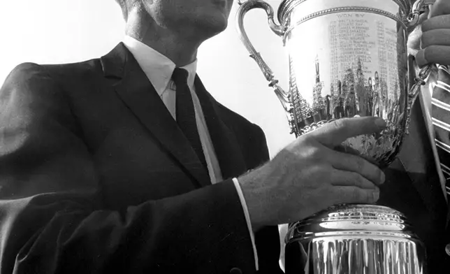 FILE - Gary Player is shown holding the huge silver cup which he won along with $26,000 and the new title of U.S. Open golf champion, June 21, 1965, at Bellerive Country Club in St. Louis, Mo. (AP Photo/File)