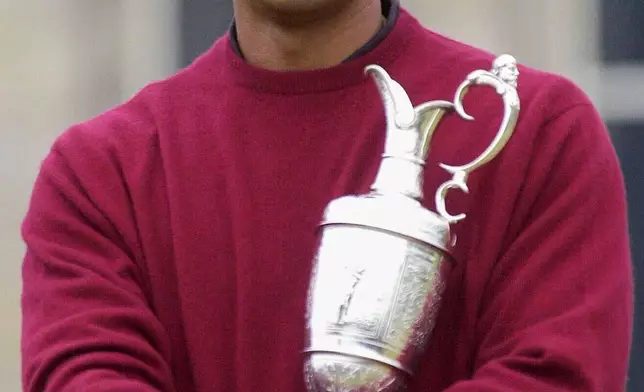 Tiger Woods, of the United States, cradles the Claret Jug after winning the British Open Golf championship on the Old Course at St. Andrews, Scotland, Sunday, July 23, 2000. (AP Photo/Adam Butler, File)