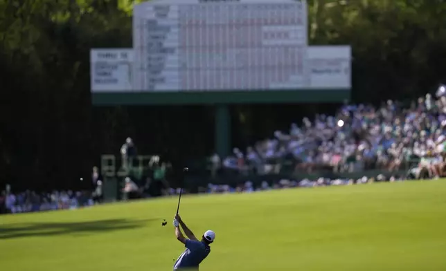 Scottie Scheffler hits from the fairway on the 13th hole during the second round at the Masters golf tournament, Friday, April 11, 2025, in Augusta, Ga. (AP Photo/Ashley Landis)