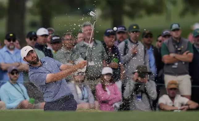Scottie Scheffler hits from the bunker on the 15th hole during the second round at the Masters golf tournament, Friday, April 11, 2025, in Augusta, Ga. (AP Photo/David J. Phillip)