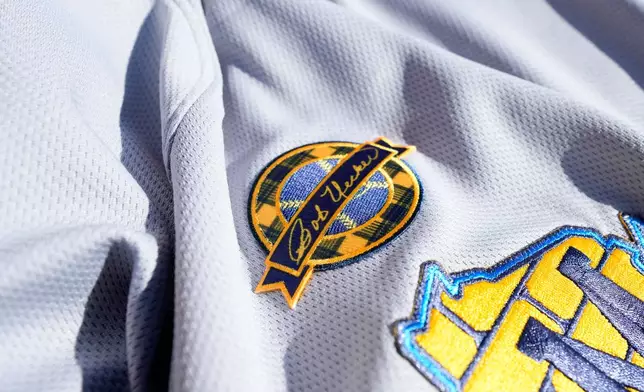 A Bob Uecker memorial patch adorns a Milwaukee Brewers jersey at a baseball game against the Kansas City Royals, Monday, March 31, 2025, in Milwaukee. (AP Photo/Kayla Wolf)