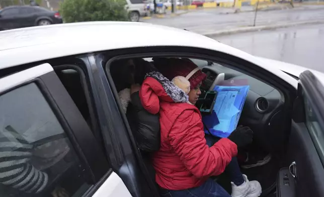 FILE - Migrants seeking asylum in the United States load into a taxi after immigration officers turned them away from their scheduled meetings soon after President Donald Trump canceled the CBP One app, Jan. 20, 2025, in Matamoros, Mexico. (AP Photo/Eric Gay, File)