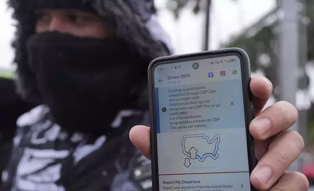 FILE - A migrant seeking asylum holds up the CBP One app showing his appointment was canceled after President Donald Trump was sworn into office, Jan. 20, 2025, in Matamoros, Mexico. (AP Photo/Eric Gay, File)