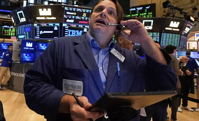Trader Michael Milano works on the floor of the New York Stock Exchange, Wednesday, April 23, 2025. (AP Photo/Richard Drew)