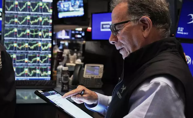 Trader Sal Suarino works on the floor of the New York Stock Exchange, Wednesday, April 23, 2025. (AP Photo/Richard Drew)