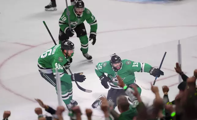 Dallas Stars center Colin Blackwell (15) celebrates his game-winning goal with teammates defenseman Ilya Lyubushkin (46) and center Sam Steel (18) during overtime in Game 2 of a first-round NHL hockey playoff series against the Colorado Avalanche early Tuesday, April 22, 2025, in Dallas. (AP Photo/Julio Cortez)