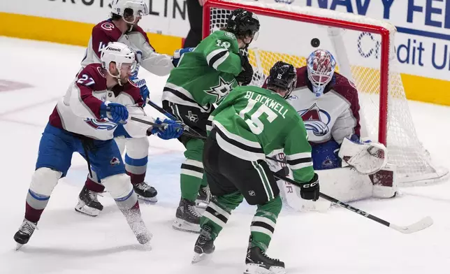 A shot by Dallas Stars center Colin Blackwell (15) gets by Colorado Avalanche goaltender Mackenzie Blackwood, right, for the game-winning goal during overtime in Game 2 of a first-round NHL hockey playoff series early Tuesday, April 22, 2025, in Dallas. (AP Photo/Julio Cortez)