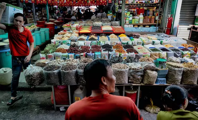 Spice and dried food vendors wait for customers at the Cholon market in the Cholon district of Ho Chi Minh City, Vietnam, on Tuesday, April 29, 2025 ahead of national celebration of the 50th Anniversary of reunification and the end of the Vietnam War. (AP Photo/Richard Vogel)