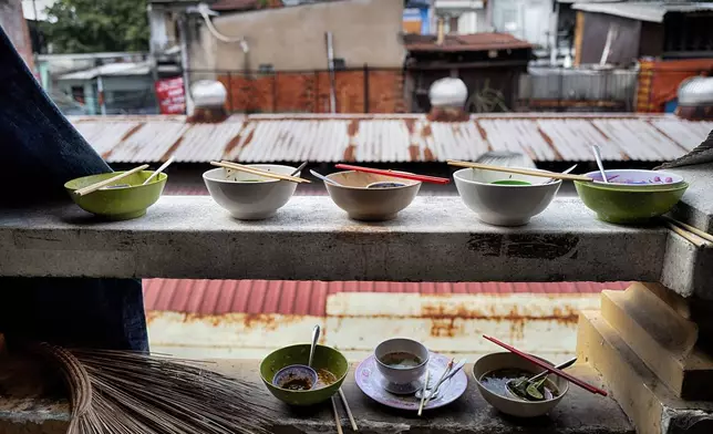 Finished breakfast bowls of pho, a Vietnamese soup, sit on a ledge in the Cholon district of Ho Chi Minh City, Vietnam, Tuesday, April 29, 2025, ahead of the 50th anniversary of the end of the Vietnamese War. (AP Photo/Richard Vogel)