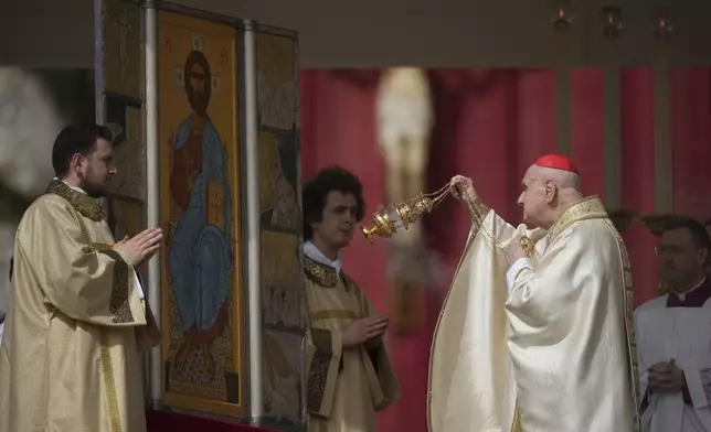Cardinal Angelo Comastri incenses the neo Acheropita icon during the Resurrexit rite at the start of the Easter mass he presided over in St. Peter's Square at the Vatican Sunday, April 20, 2025. (AP Photo/Andrew Medichini)
