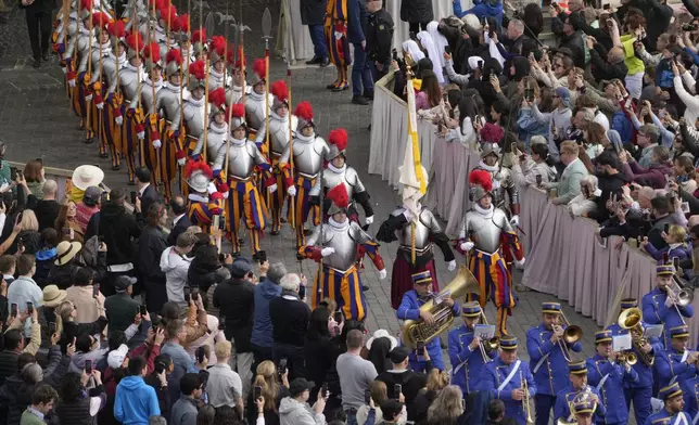 Pontifical Swiss guards arrive for the Easter mass in St. Peter's Square at the Vatican Sunday, April 20, 2025. (AP Photo/Gregorio Borgia)