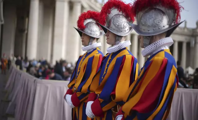 Pontifical Swiss guards wait for the start of the Easter mass in St. Peter's Square at the Vatican Sunday, April 20, 2025. (AP Photo/Andrew Medichini)
