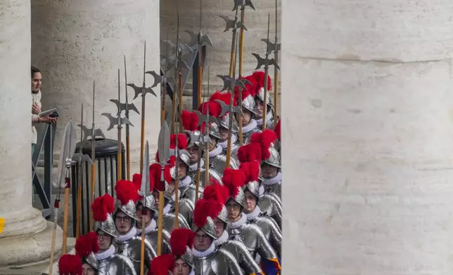 Pontifical Swiss guards arrive for the Easter mass in St. Peter's Square at the Vatican Sunday, April 20, 2025. (AP Photo/Gregorio Borgia)