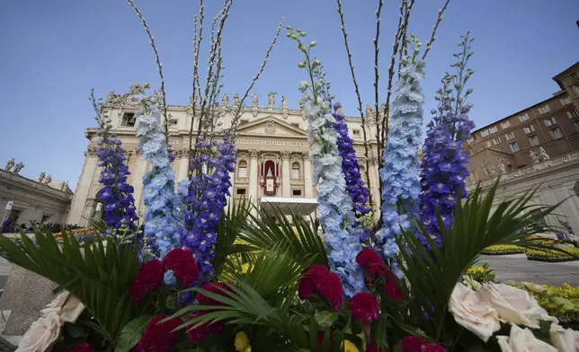 Flowers are set up for the Easter mass in St. Peter's Square at the Vatican Sunday, April 20, 2025. (AP Photo/Andrew Medichini)