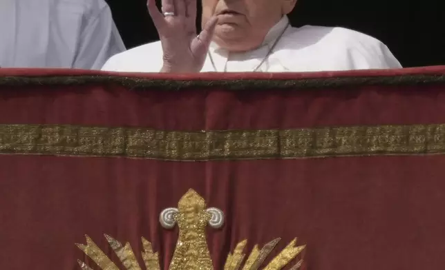 Pope Francis appears on the central lodge of St. Peter's Basilica to bestow the Urbi et Orbi (Latin for to the city and the world) blessing at the end of the Easter mass presided over by Cardinal Angelo Comastri in St. Peter's Square at the Vatican Sunday, April 20, 2025. (AP Photo/Andrew Medichini)