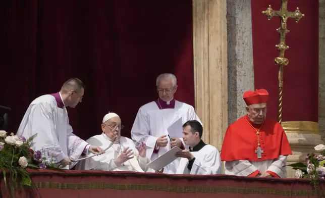 Pope Francis appears on the central lodge of St. Peter's Basilica to bestow the Urbi et Orbi (Latin for to the city and the world) blessing at the end of the Easter mass presided over by Cardinal Angelo Comastri in St. Peter's Square at the Vatican Sunday, April 20, 2025. (AP Photo/Gregorio Borgia)