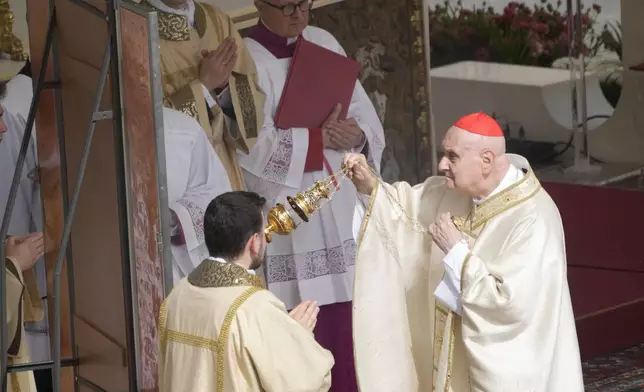 Cardinal Angelo Comastri presides over the Easter mass in St. Peter's Square at the Vatican Sunday, April 20, 2025. (AP Photo/Gregorio Borgia)