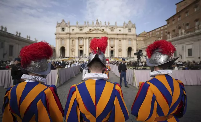 Pontifical Swiss guards wait for the start of the Easter mass in St. Peter's Square at the Vatican Sunday, April 20, 2025. (AP Photo/Andrew Medichini)
