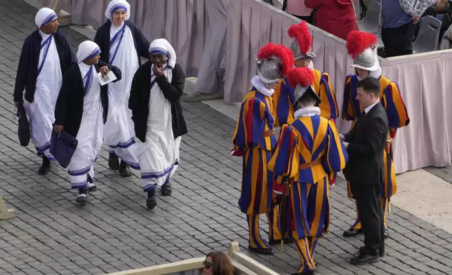 Missionaries of Charity nuns arrive for the Easter mass in St. Peter's Square at the Vatican Sunday, April 20, 2025. (AP Photo/Gregorio Borgia)