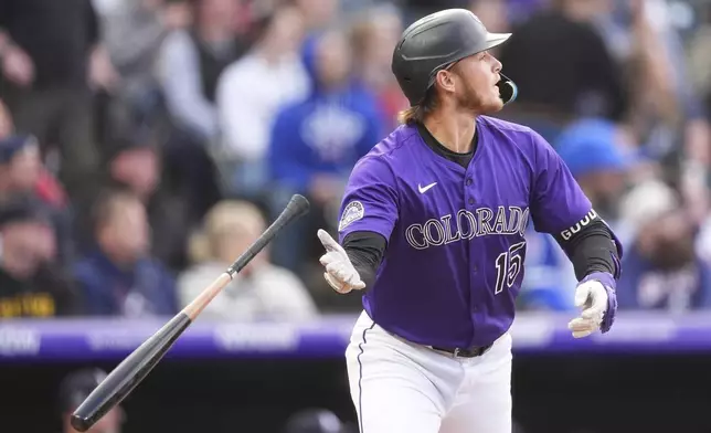 Colorado Rockies' Hunter Goodman tosses his bat as he heads up the first base line after hitting a three-run home run off Atlanta Braves starting pitcher Bryce Elder in the first inning of a baseball game Monday, April 28, 2025, in Denver. (AP Photo/David Zalubowski)