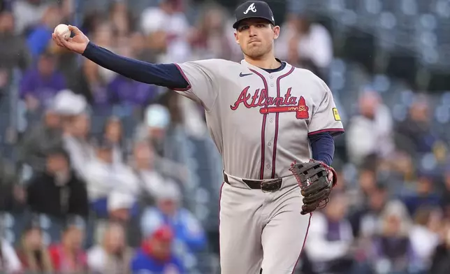 Atlanta Braves third baseman Austin Riley throws to first base to put out Colorado Rockies' Jacob Stallings in the second inning of a baseball game Monday, April 28, 2025, in Denver. (AP Photo/David Zalubowski)