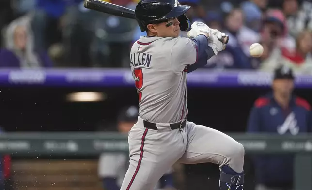 Atlanta Braves' Nick Allen hits an infield single to drive in a run off Colorado Rockies starting pitcher Ryan Feltner in the fourth inning of a baseball game Monday, April 28, 2025, in Denver. (AP Photo/David Zalubowski)
