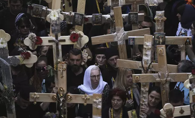 Christian pilgrims carry crosses during Good Friday procession in the Old City of Jerusalem on Friday, April 18, 2025. (AP Photo/Mahmoud Illean)