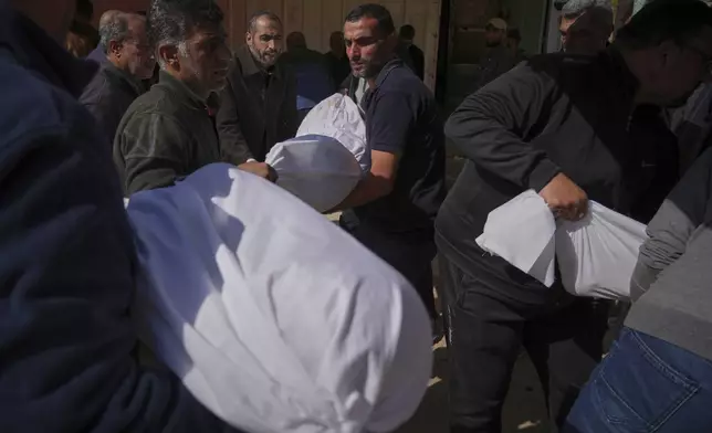 Palestinians prepare for burial the bodies of several members of the al-Atal family, killed in an Israeli airstrike on a tent in the Jabalia refugee camp, at the Indonesian hospital in Beit Lahia, northern Gaza Strip, Thursday, April 17, 2025.(AP Photo/(AP Photo/Jehad Alshrafi)