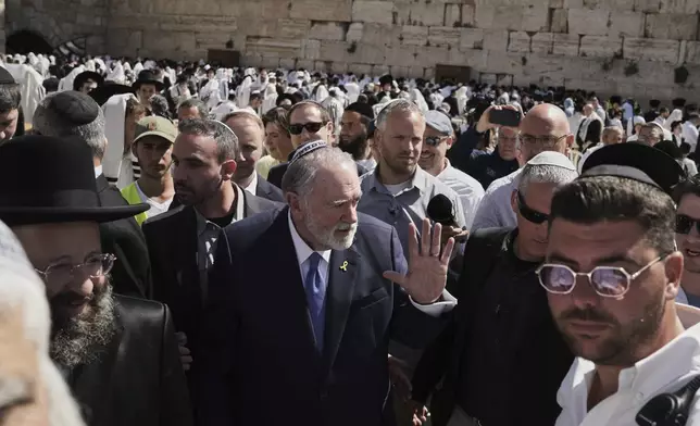 US ambassador to Israel Mike Huckabee, center, visits the Western Wall, the holiest site where Jews can pray, in the Old City of Jerusalem, Friday, April 18, 2025. (AP Photo/Leo Correa)