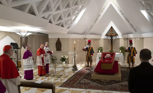 Pope Francis's body is laid out in state inside his private chapel at the Vatican, Monday, April 21, 2025. From left, Secretary of State Pietro Parolin, Master of Ceremonies Archbishop Diego Giovanni Ravelli, Cardinal Camerlengo Kevin Joseph Farrell, and Master of Ceremonies Lubomir Welnitz. (Vatican Media via AP, HO)