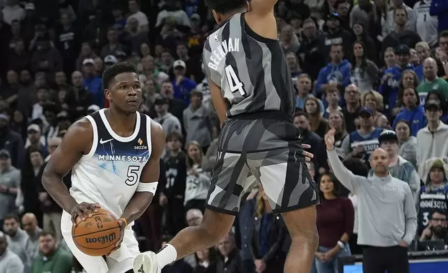 Minnesota Timberwolves guard Anthony Edwards (5) looks to shoot as Brooklyn Nets guard Reece Beekman (4) defends during the first half of an NBA basketball game, Friday, April 11, 2025, in Minneapolis. (AP Photo/Abbie Parr)