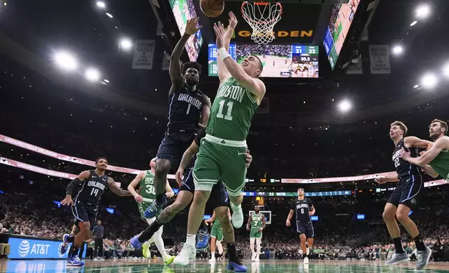 Boston Celtics guard Payton Pritchard (11) is fouled by Orlando Magic guard Anthony Black (0) during the first half in game 2 of a first-round NBA playoff basketball series, Wednesday, April 23, 2025, in Boston. (AP Photo/Charles Krupa)