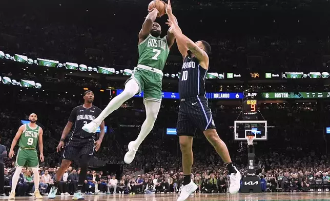 Boston Celtics guard Jaylen Brown (7) takes a shot while pressured by Orlando Magic guard Cory Joseph (10) during the first half in game 2 of a first-round NBA playoff basketball series, Wednesday, April 23, 2025, in Boston. (AP Photo/Charles Krupa)