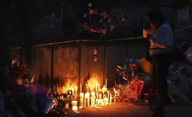 Liza Ahyeng wipes away tears at a memorial for victims after a vehicle drove into a crowd during a Filipino heritage festival in Vancouver, British Columbia, Sunday, April 27, 2025. (AP Photo/Lindsey Wasson)