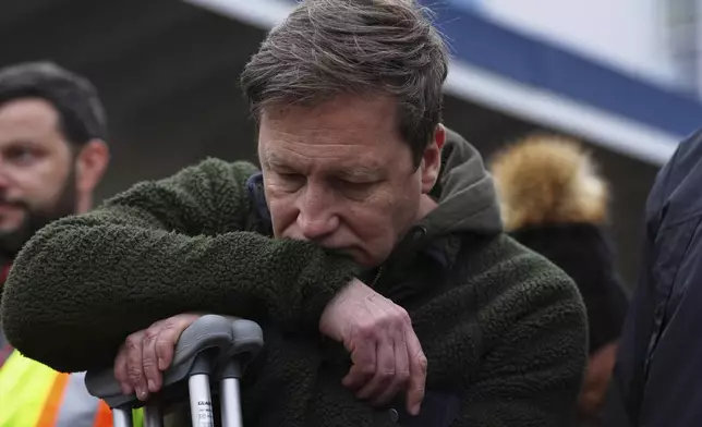 Noel Johansen, whose wife Jenifer Darbellay died after a vehicle drove into a crowd during a Filipino heritage festival, reacts at a vigil outside Sir Alexander Mackenzie Elementary School in Vancouver, British Columbia, Monday, April 28, 2025. (AP Photo/Lindsey Wasson)