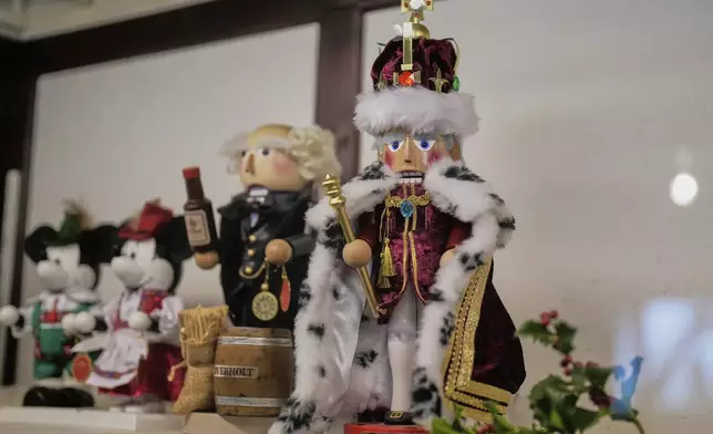 A nutcracker commemorating the coronation of Britain's King Charles III, right, stands alongside other nutcrackers at the Steinbach-Volkskunst nutcracker factory in Marienberg, Germany, Tuesday, April 15, 2025. (AP Photo/Markus Schreiber)