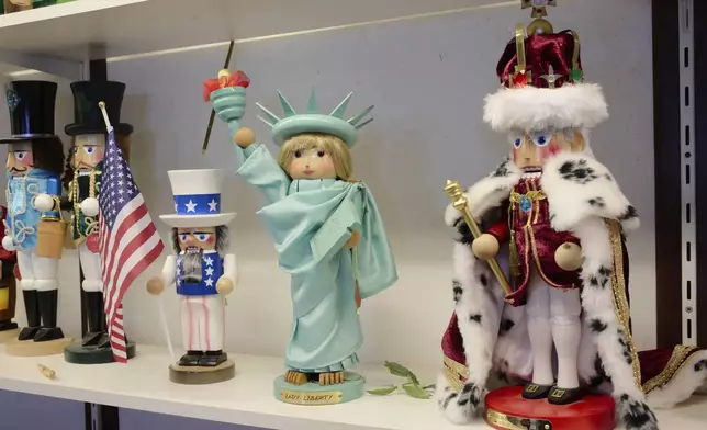 From right, nutcrackers showing Britain's King Charles III, Statue of Liberty and Uncle Sam are displayed at the Steinbach-Volkskunst nutcracker factory in Marienberg, Germany, Tuesday, April 15, 2025. (AP Photo/Markus Schreiber)