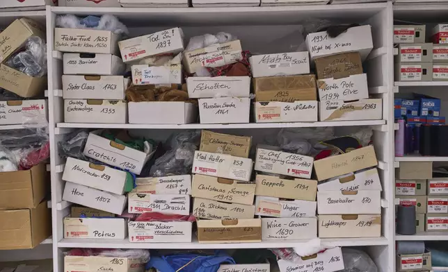 Fabrics for nutcracker costumes are stored on the shelf at the Steinbach-Volkskunst nutcracker factory in Marienberg, Germany, Tuesday, April 15, 2025. (AP Photo/Markus Schreiber)