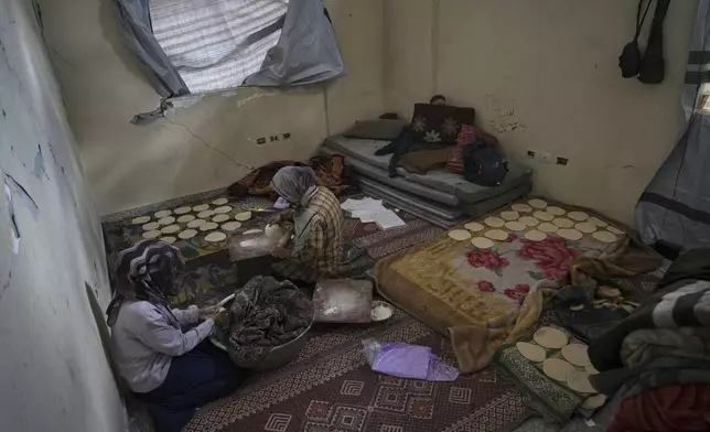 Members of the Za'anin family live at the Islamic University in Gaza City, which is now a shelter for displaced Palestinians amid the ongoing war in Gaza, Saturday, April 5, 2025. (AP Photo/Jehad Alshrafi)