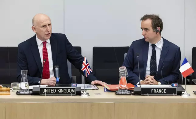 Britain's Defense Secretary John Healey, left, sits next to French Defense Minister Sebastien Lecornu as he talks during a coalition of the willing defence ministers meeting at NATO headquarters in Brussels, Belgium, Thursday, April 10, 2025. (AP Photo/Geert Vanden Wijngaert)
