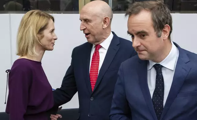 European Union foreign policy chief Kaja Kallas, left, speaks with Britain's Defense Secretary John Healey, center, as French Defense Minister Sebastien Lecornu arrives for a coalition of the willing defence ministers meeting at NATO headquarters in Brussels, Belgium, Thursday, April 10, 2025. (AP Photo/Geert Vanden Wijngaert)