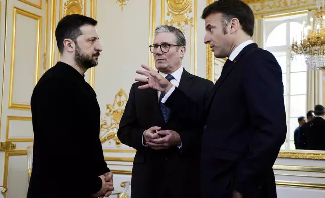 Ukraine's President Volodymyr Zelenskyy, left, French President Emmanuel Macron, right, and Britain's Prime Minister Keir Starmer speak during a trilateral meeting on the sidelines of a summit for "coalition of the willing" at the Elysee Palace, Thursday, March 27, 2025. (Ludovic Marin, Pool via AP)