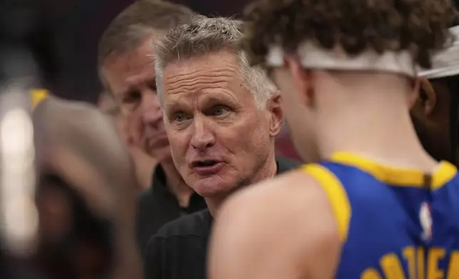 Golden State Warriors head coach Steve Kerr talks to his team during the first half of Game 1 of an NBA basketball first-round playoff series against the Houston Rockets in Houston, Sunday, April 20, 2025. (AP Photo/Ashley Landis)