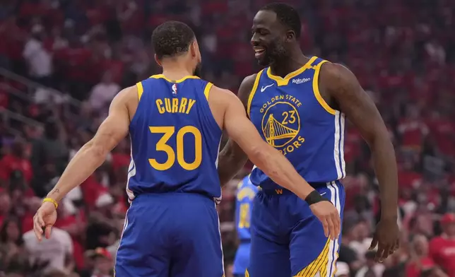 Golden State Warriors guard Stephen Curry (30) greets forward Draymond Green (23) before Game 1 of an NBA basketball first-round playoff series against the Houston Rockets in Houston, Sunday, April 20, 2025. (AP Photo/Ashley Landis)